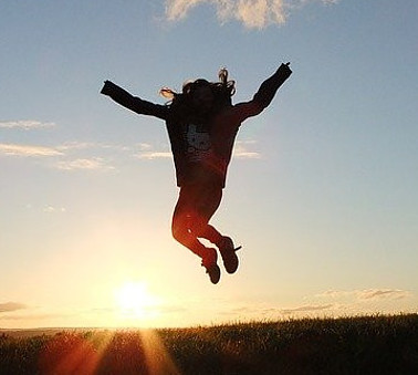 Image photo: A person is jumping high with a sunset view in the background