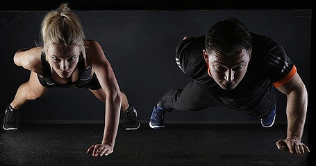 Image photo: A couple is doing commando plank workout