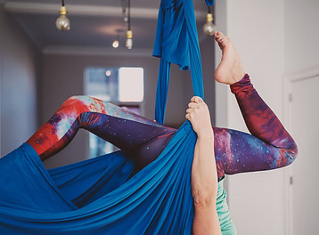 Image photo: A trainer is practicing aerial yoga at home