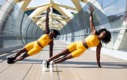 Image photo: Two trainers are doing side plank workout