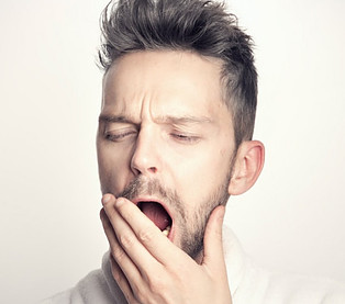 image photo: a man is expressing his tiredness due to low energy levels