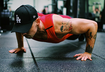 Image photo: a trainer is doing a pushup for shoulder workout